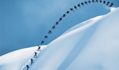 A snowboarder descends the mountain face
