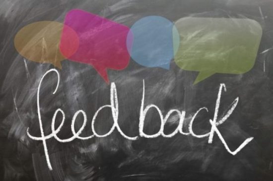 A chalkboard with the word "feedback" and speech bubbles
