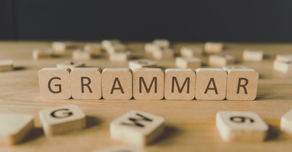 The word "grammar" spelled out in Scrabble tiles