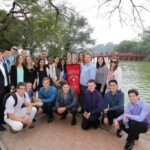 group of students in front of bridge
