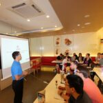 student listening to teacher in Swensen's