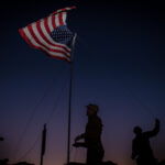 soldiers putting up flag