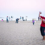 student playing at beach
