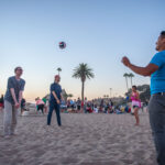 student playing beach volleyball