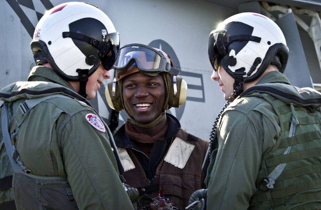 soldier smiling with two pilots