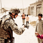 soldier with kids in rural area