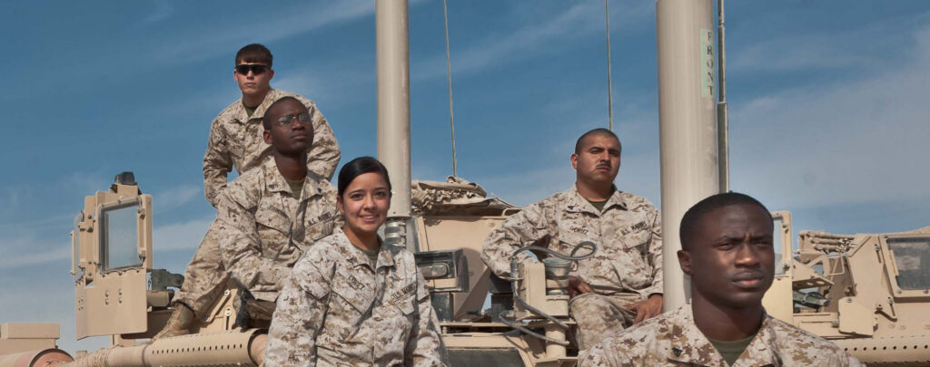 soldiers posing by tank