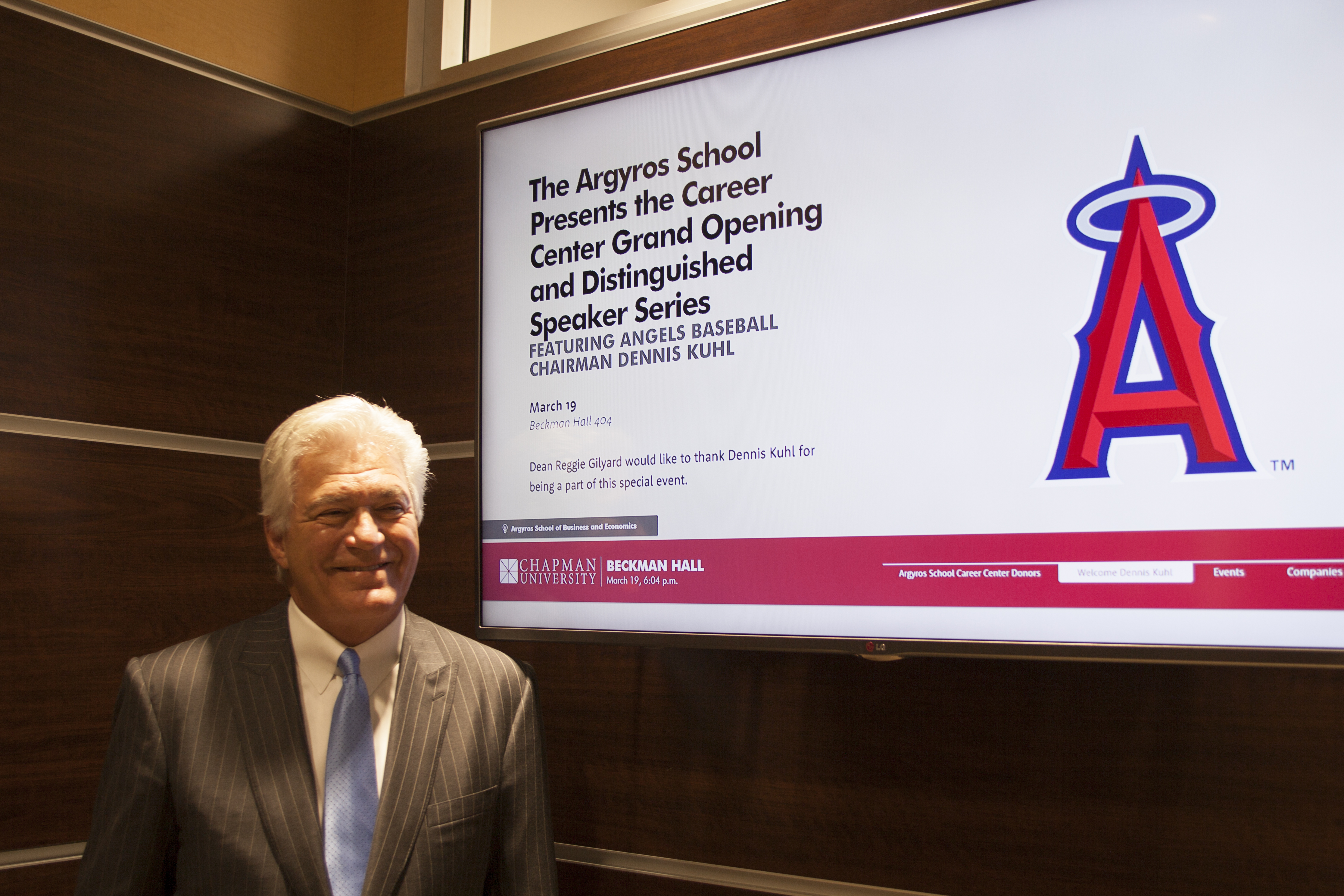 Angel Baseball Chairman next to sign