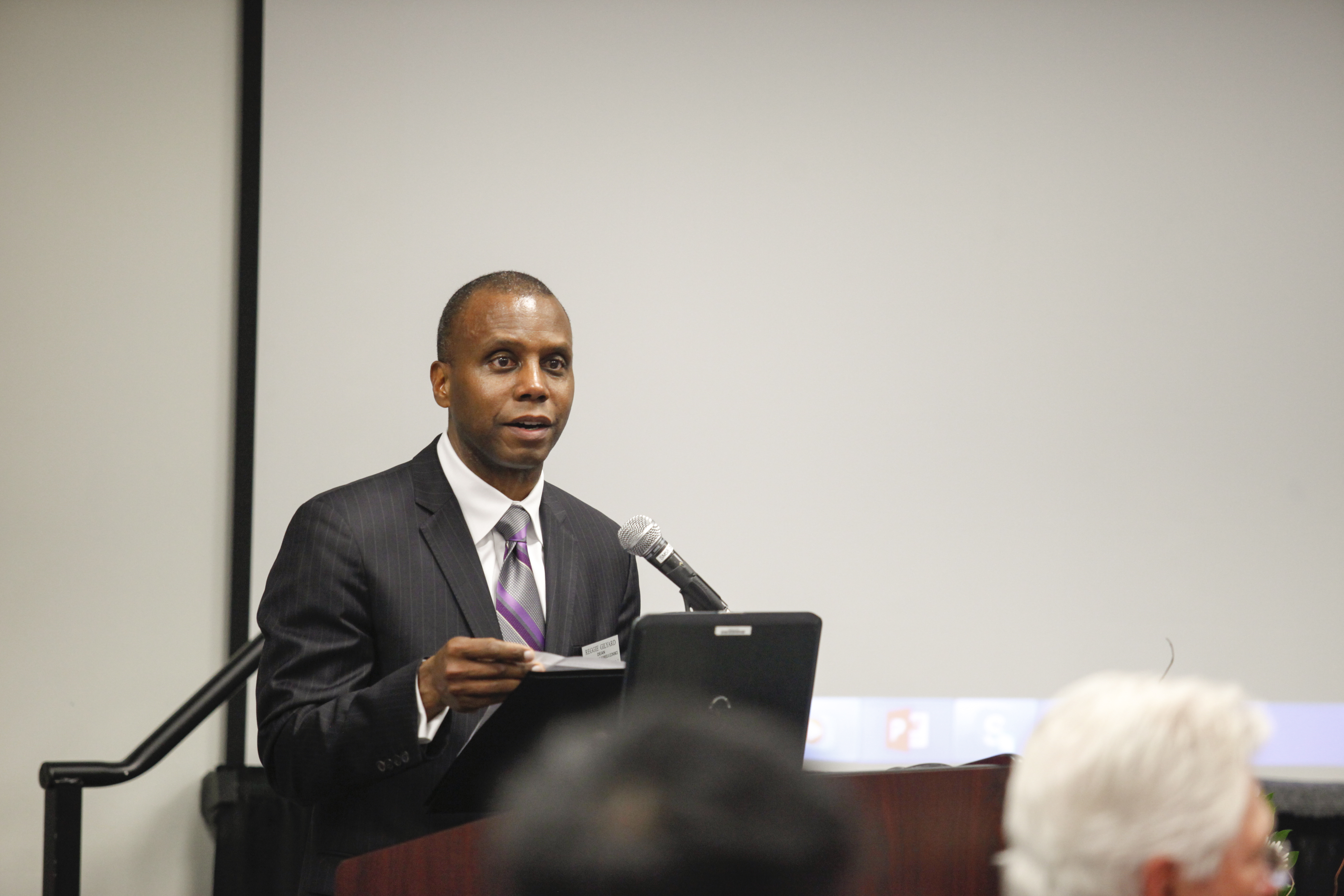 Dean Gilyard speaking at podium
