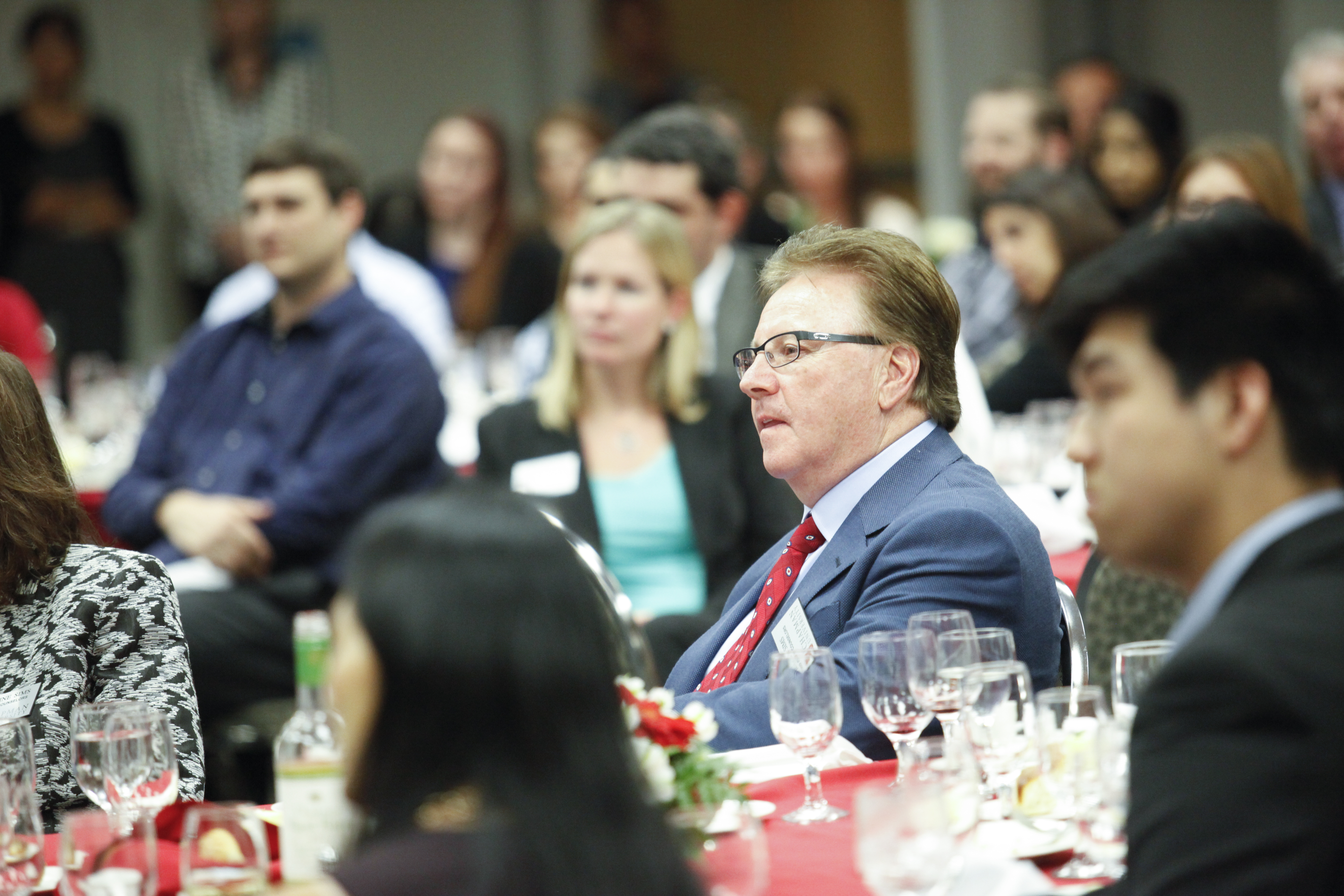 business dressed audience member listening