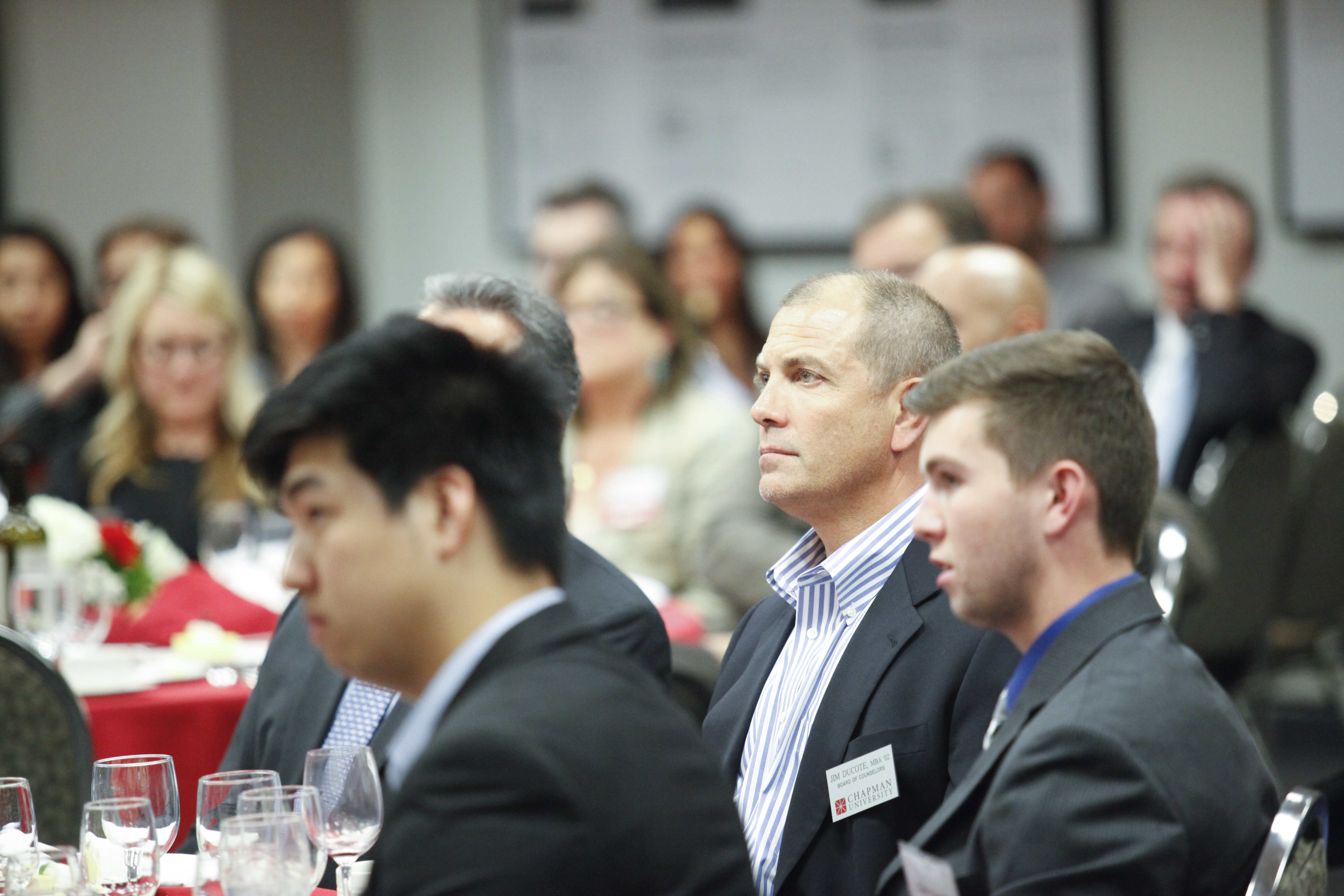 business dress audience members watching speaker