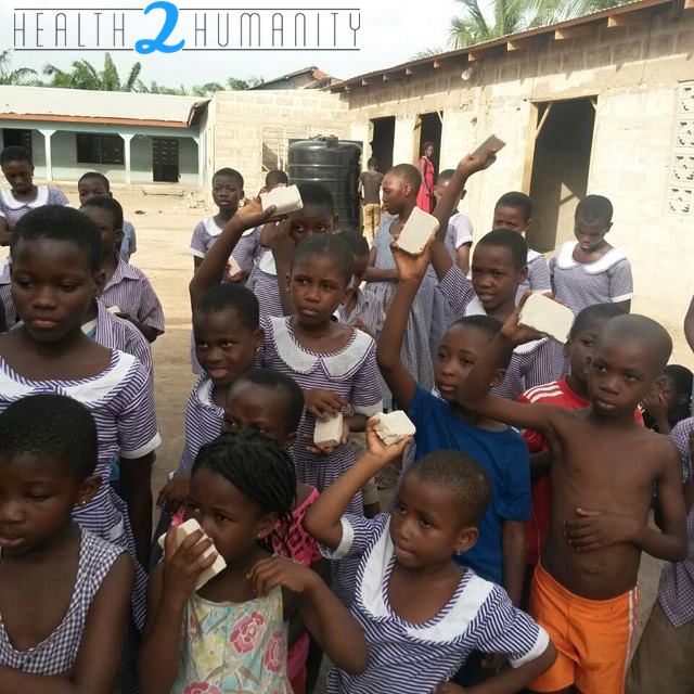 African Children holding up H2h soap
