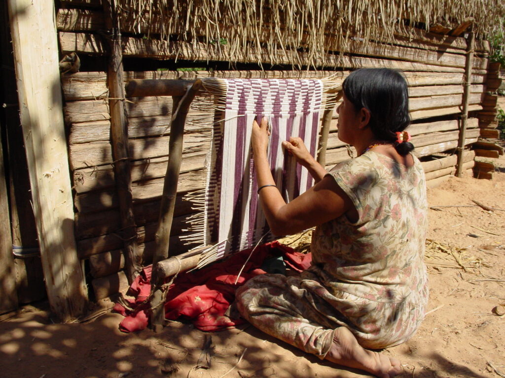 woman hand weaving a rug