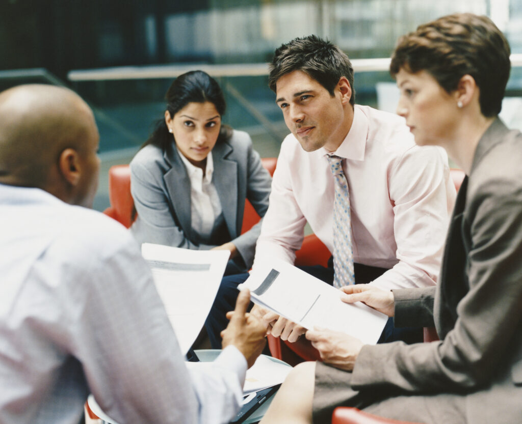 Business People Sitting in an Office Building Having a Meeting