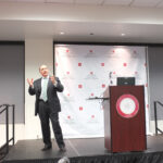 Businessman Eric Brandt speaks to the Argyros School community.