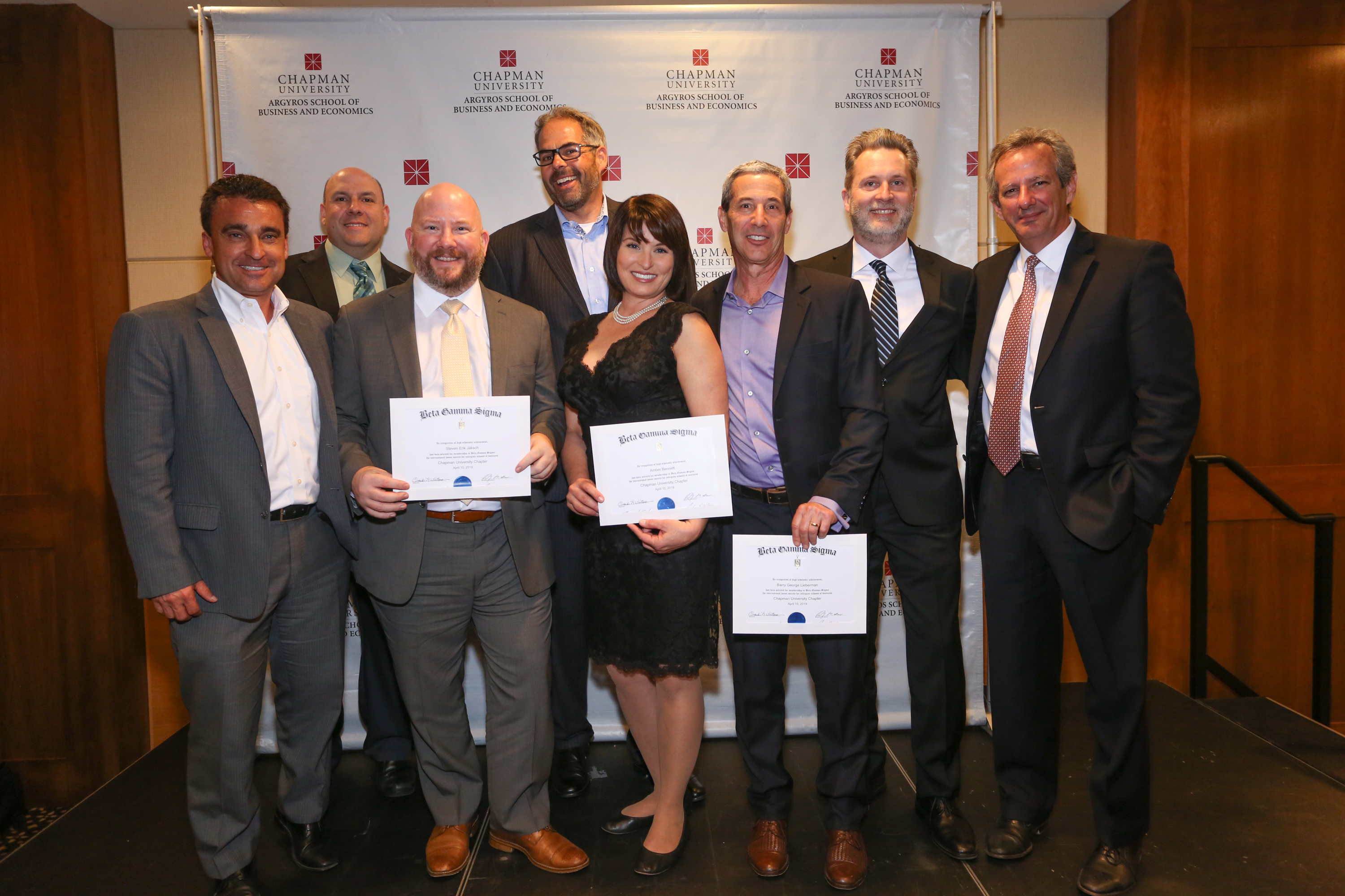 EMBA Students pose with Dean Turk and Assistant Dean Chris Lowe