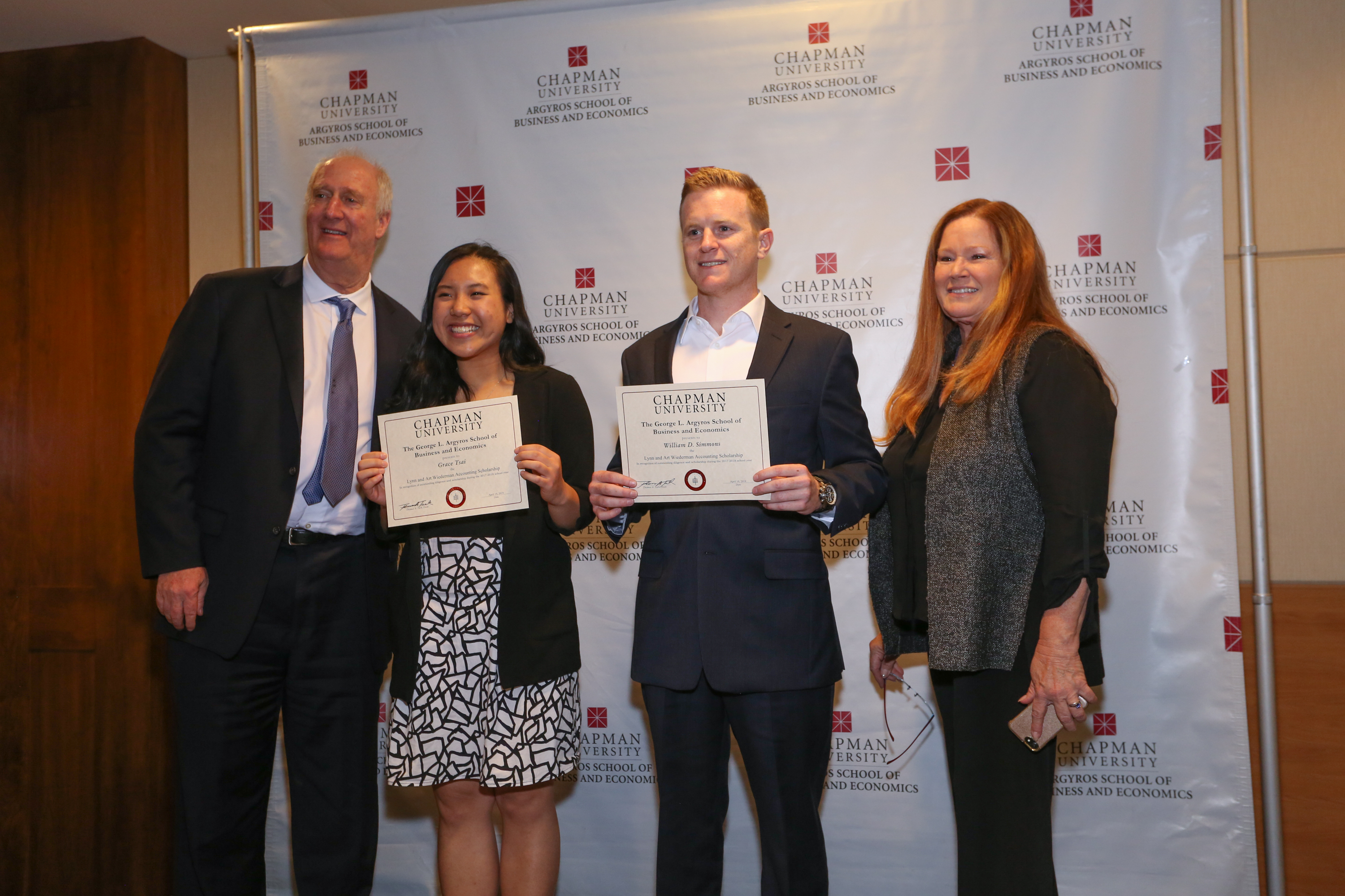 Students Grace Tsai and William Simmons pose with Lynn and Art Wiederman