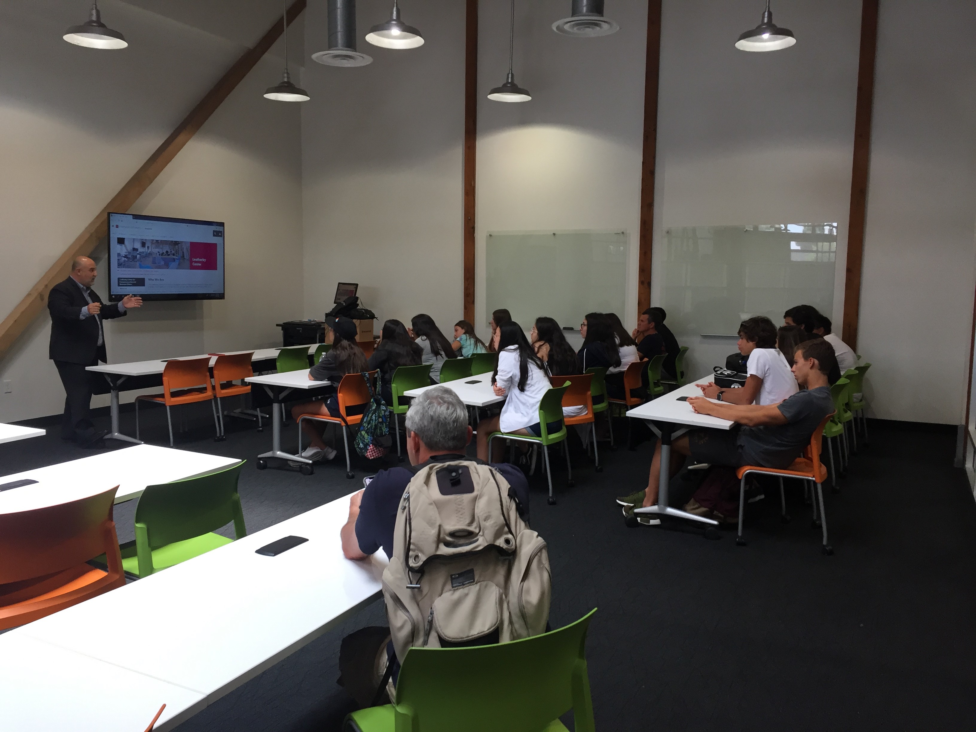 Professor giving talk to students in classroom