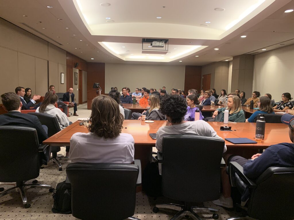 audience in board room listening to panel