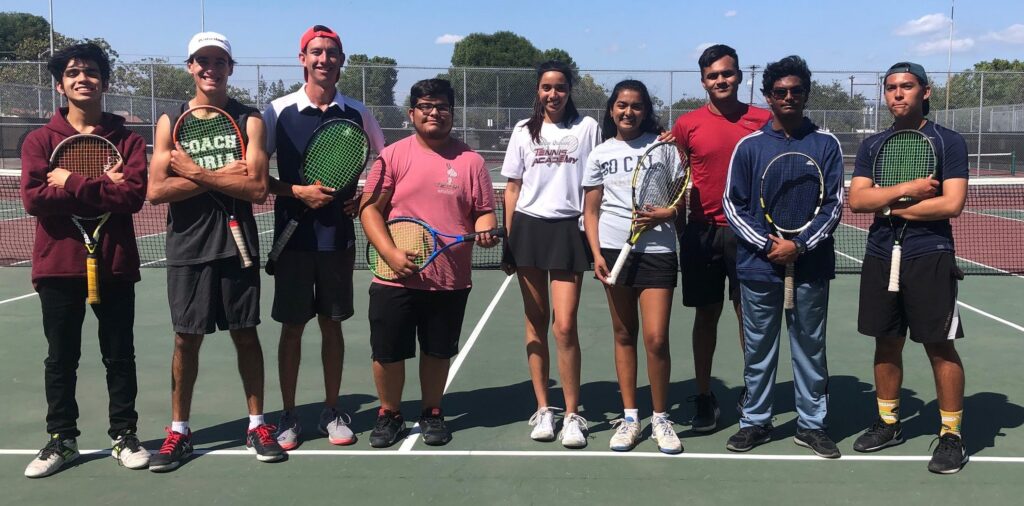 Austin Price on the tennis court with team members