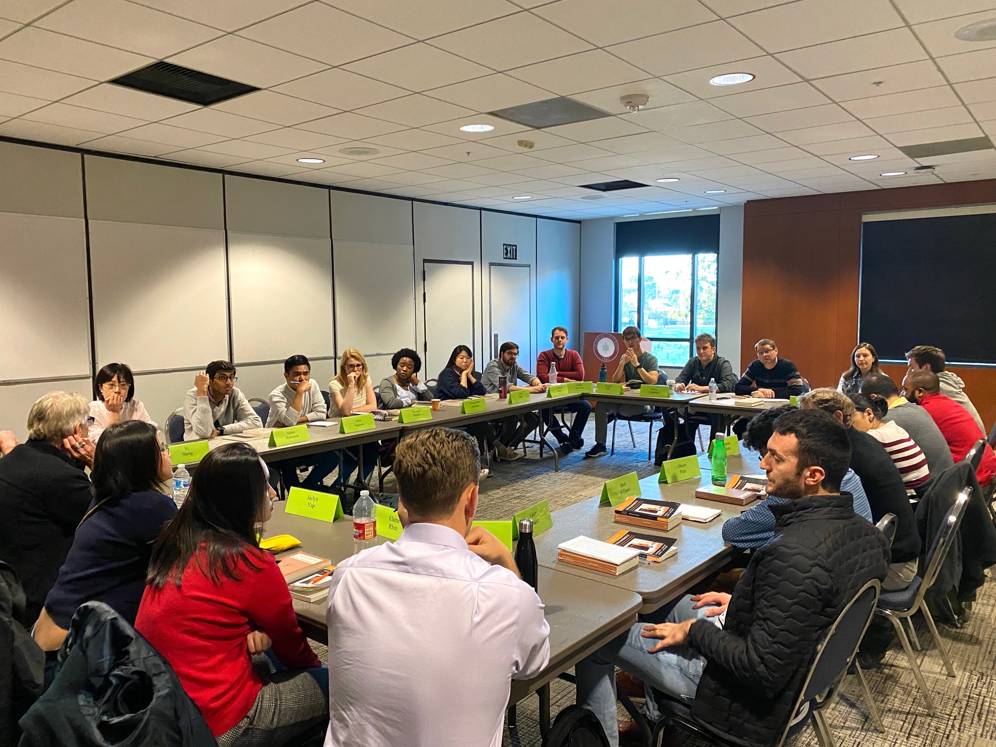 Participants seated in a circle participating in a Colloquium Discussion