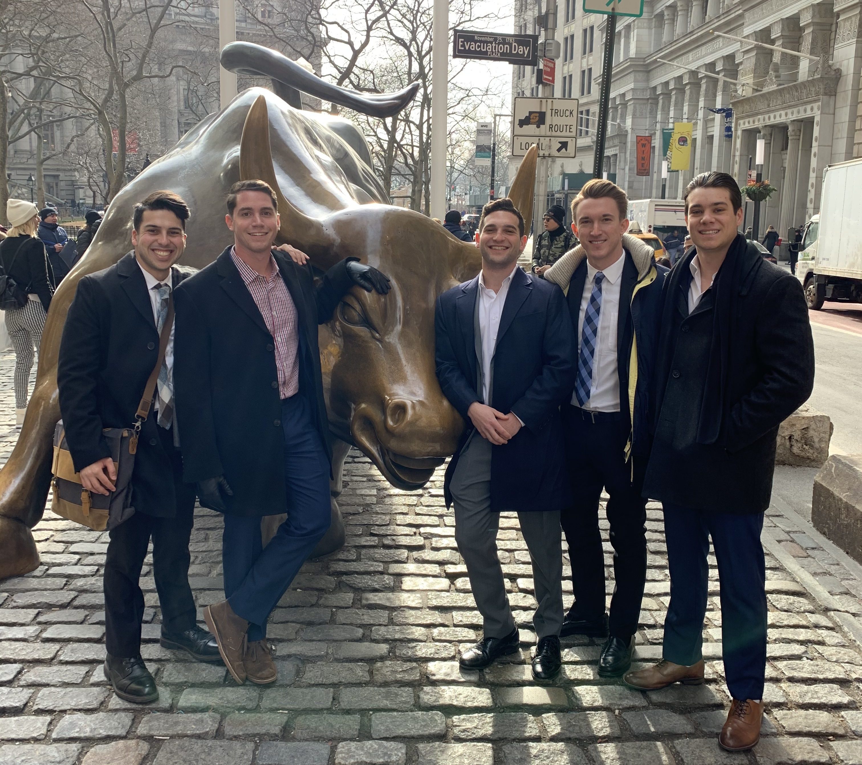5 students with famous Wall Street Bull