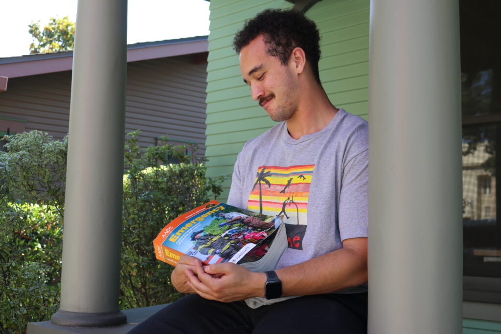 peer advisor carson is holding his emt book
