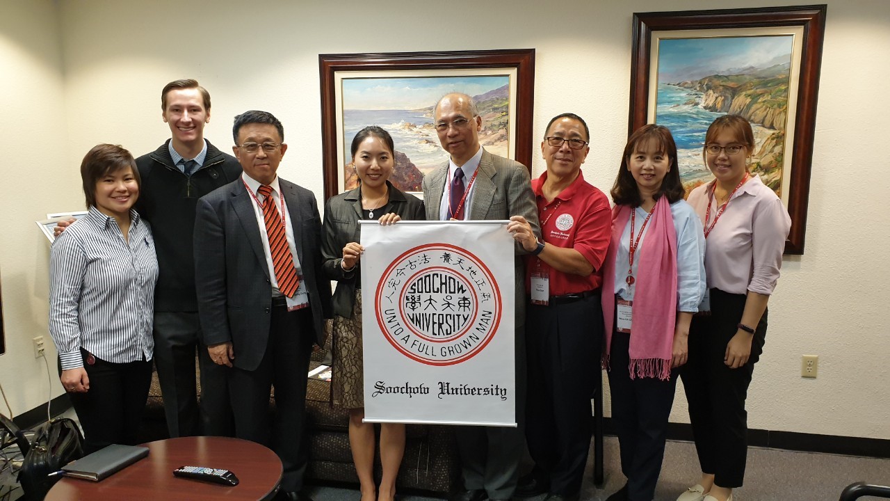 Soochow Visitors and students holding Soochow flag