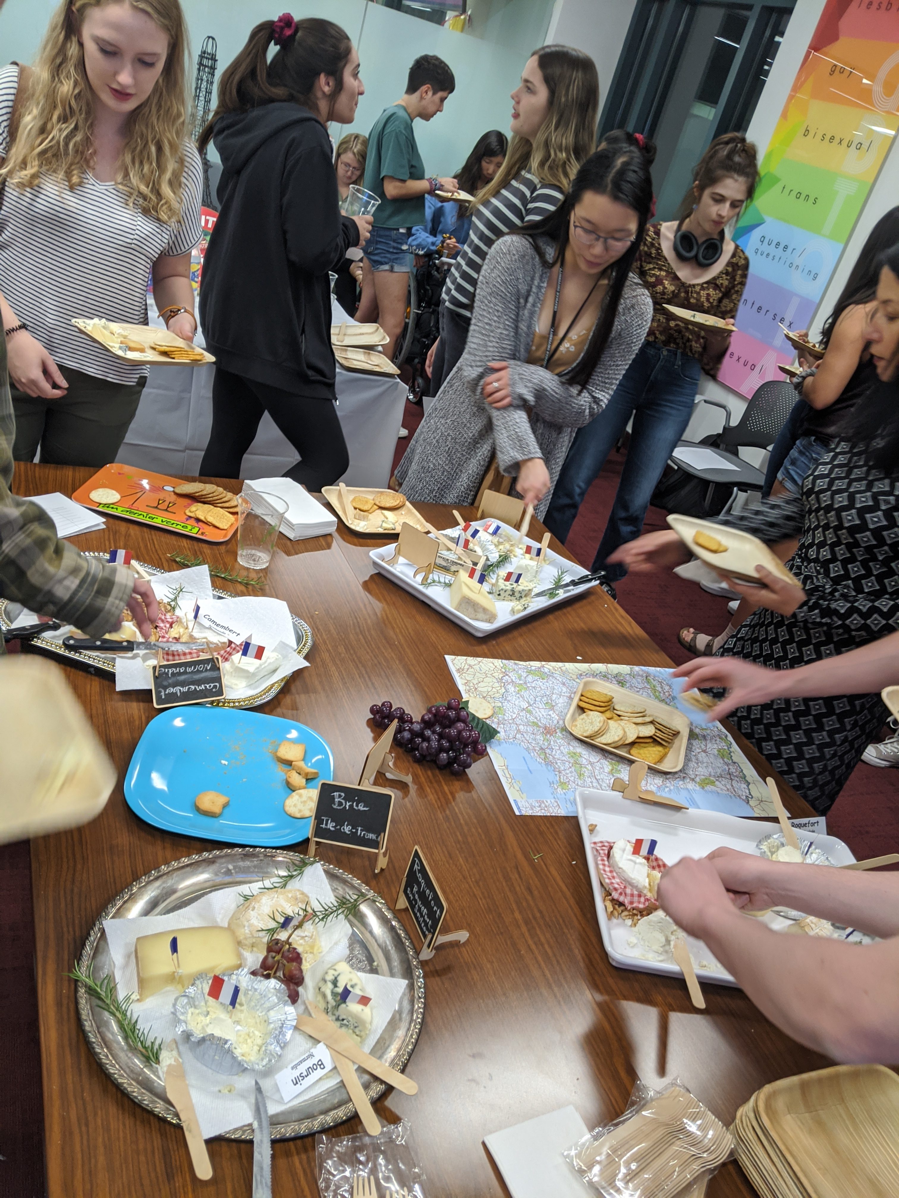 Say Cheese! Tasting Event. Students around table looking at cheese