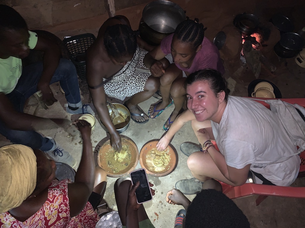 Student eating with locals