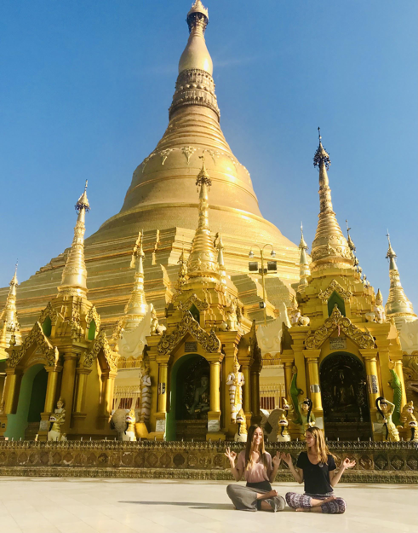 Students sitting in front of temple
