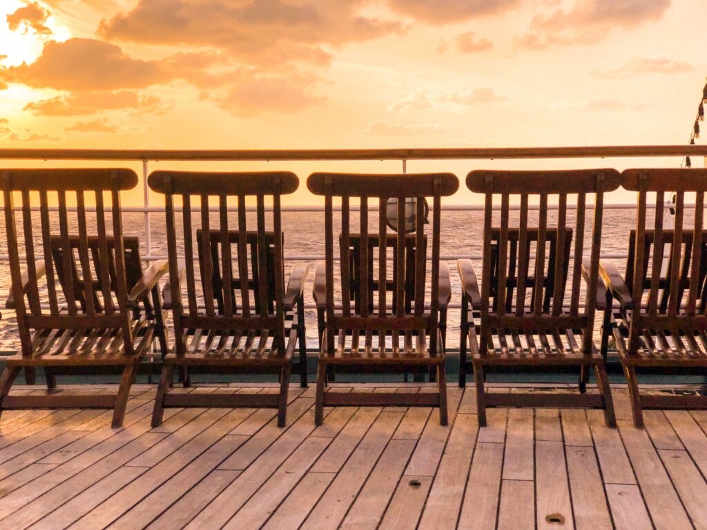 Chairs on a ship deck during sunset