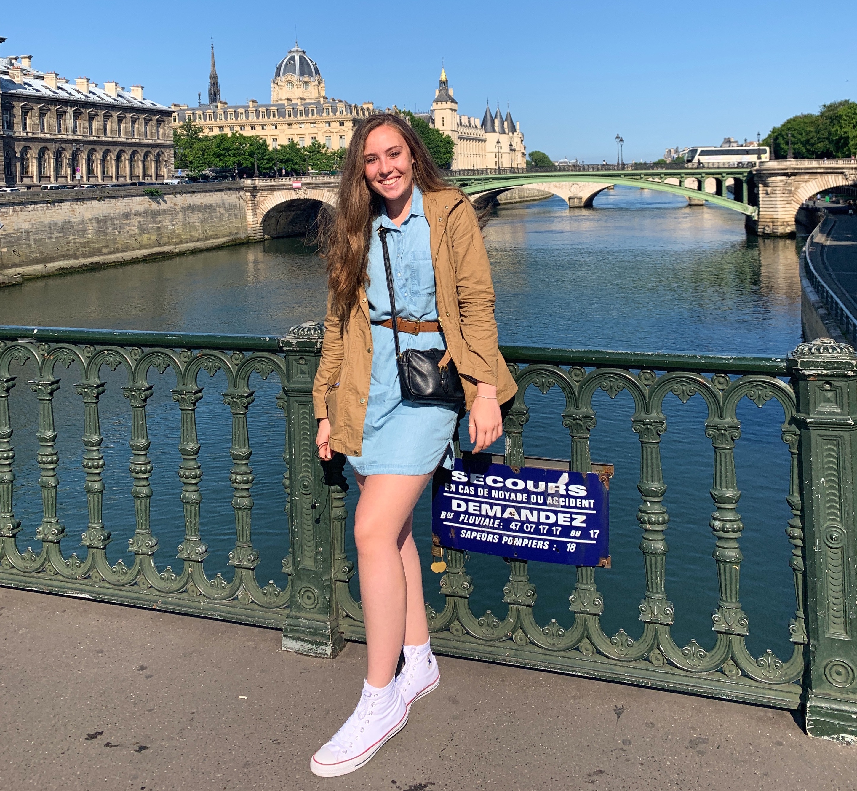 Student on bridge over water in Paris, France