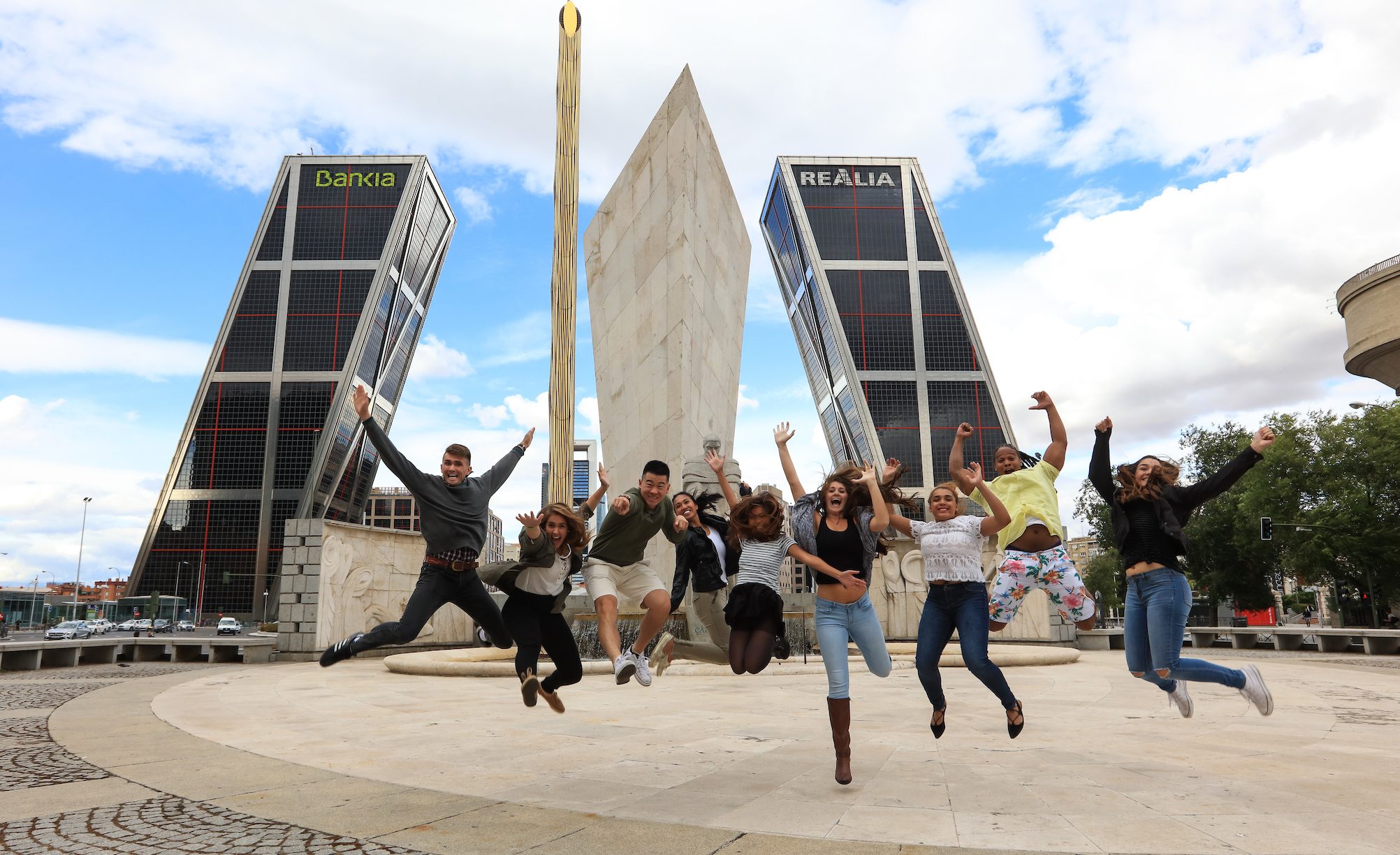 Students jumping in a plaza in Madrid, Spain