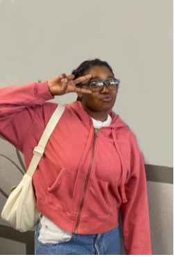 bria benton showing the peace sign across her face