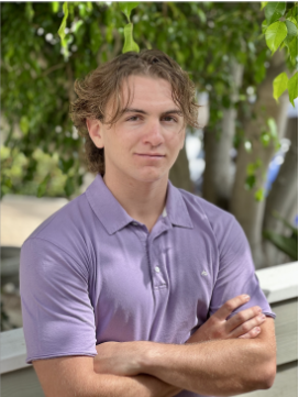 matthew molteni headshot wearing a purple polo and hair dangling over his face