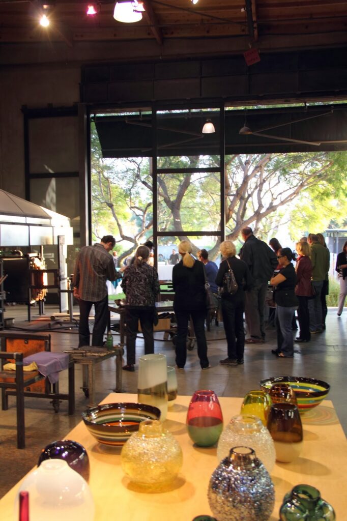group of people looking at ceramics