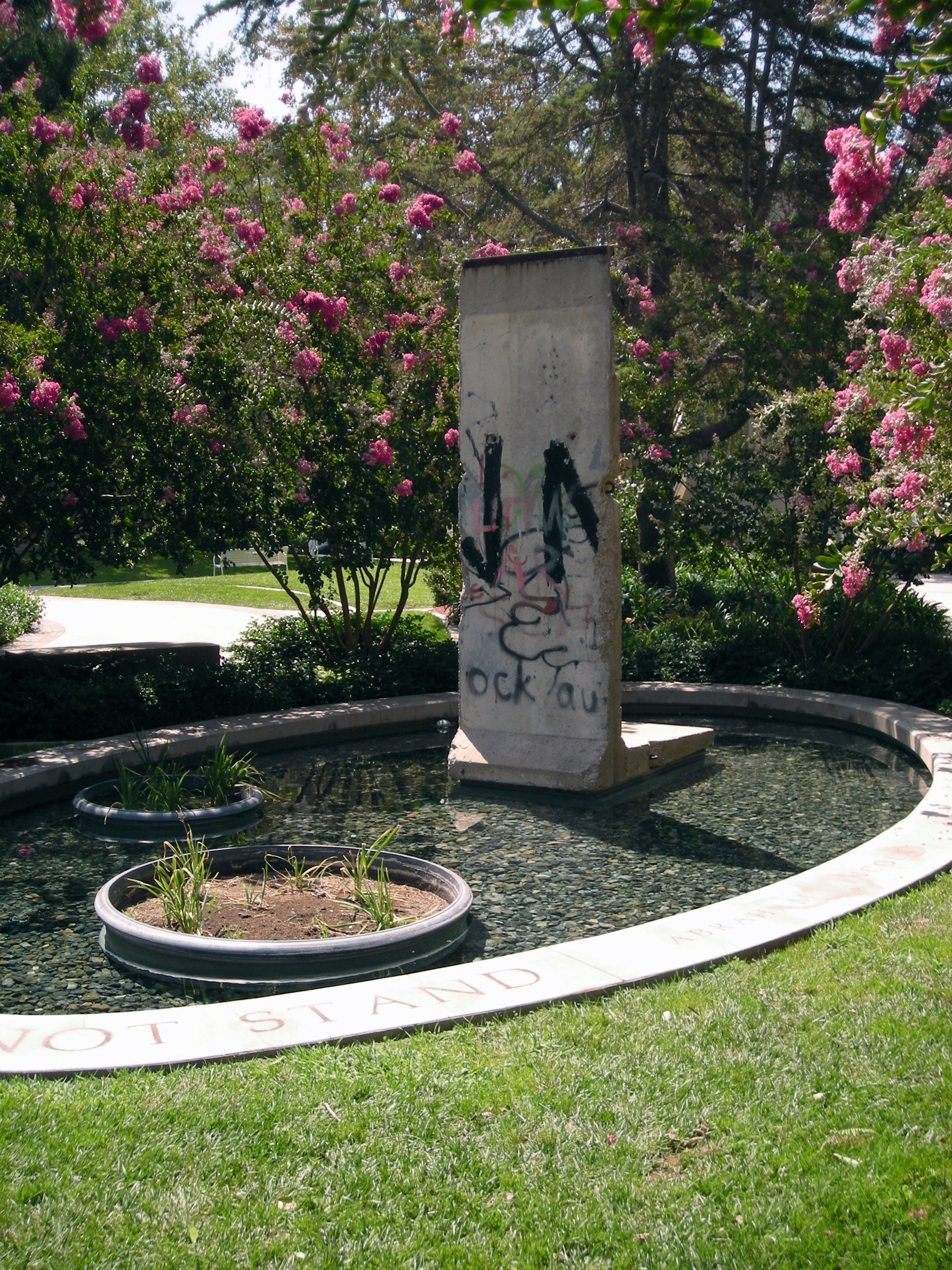 fountain and piece of the berlin wall
