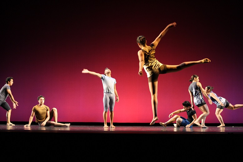 Students perform a dance performance on stage.