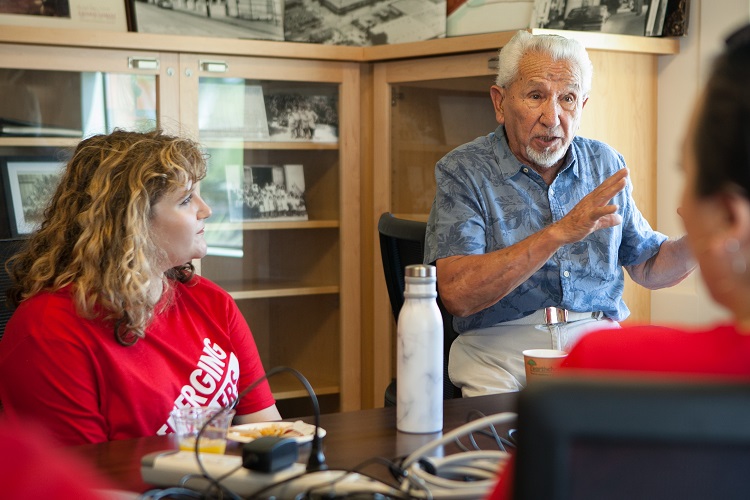 Paul Guzman, a resident of Orange, explains the history of the Cypress Street Schoolhouse