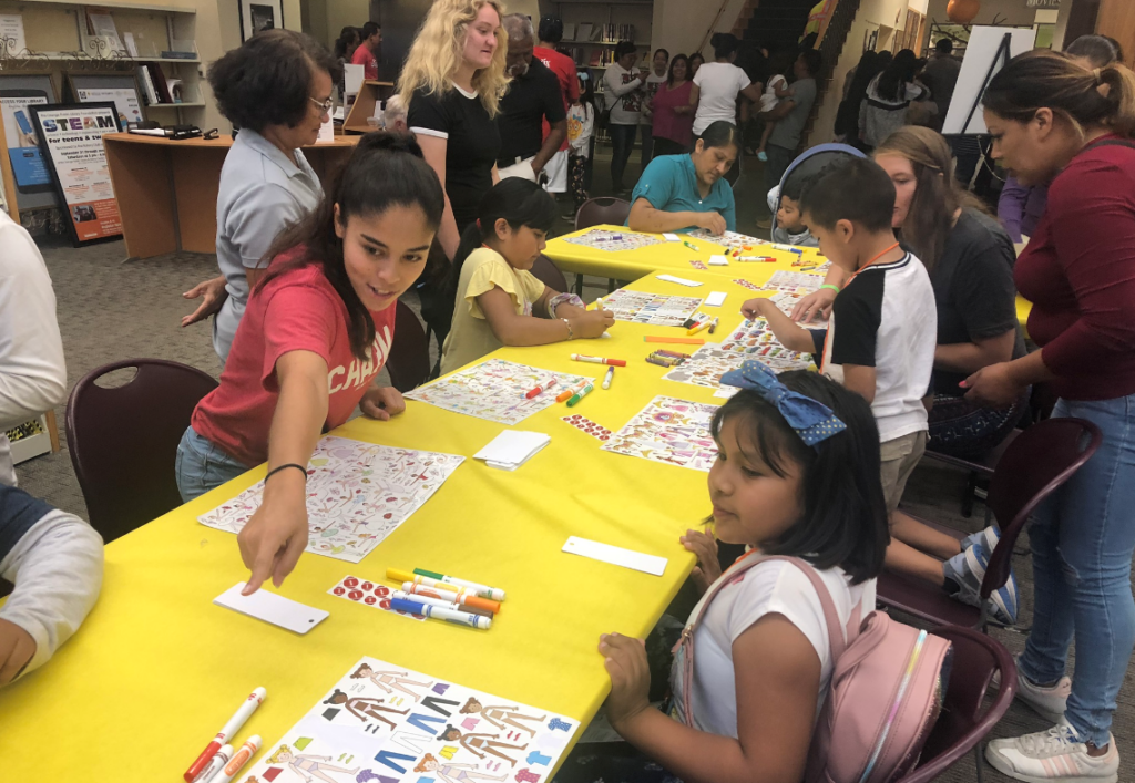 Chapman student helping with bookmarks