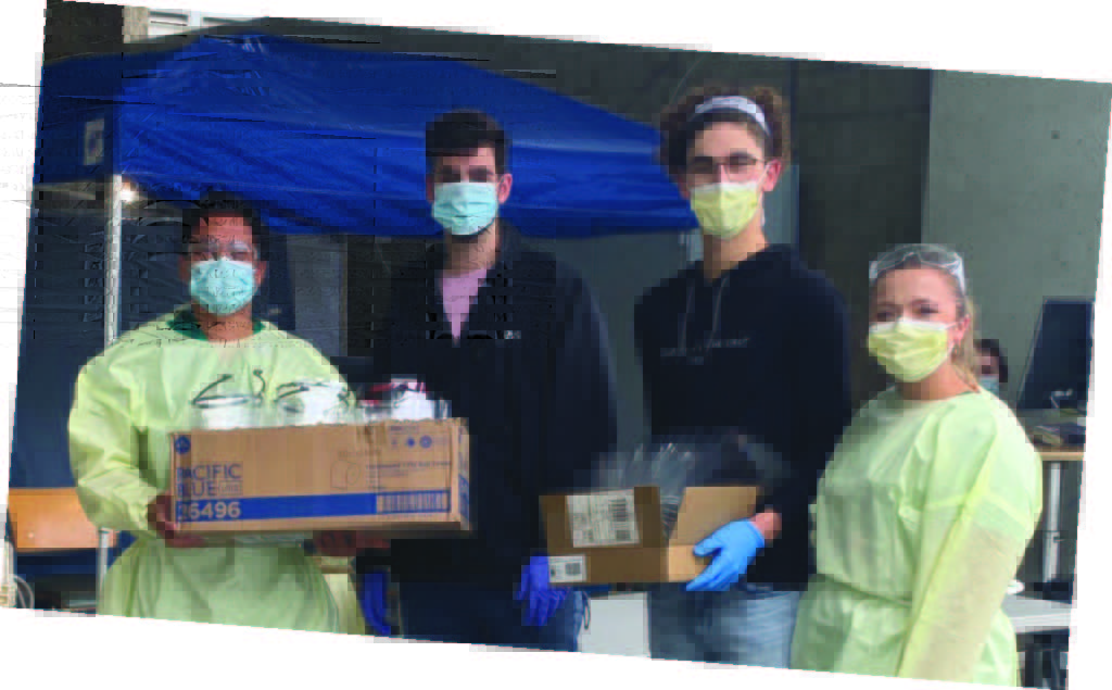 Students holding 3D printed face shields