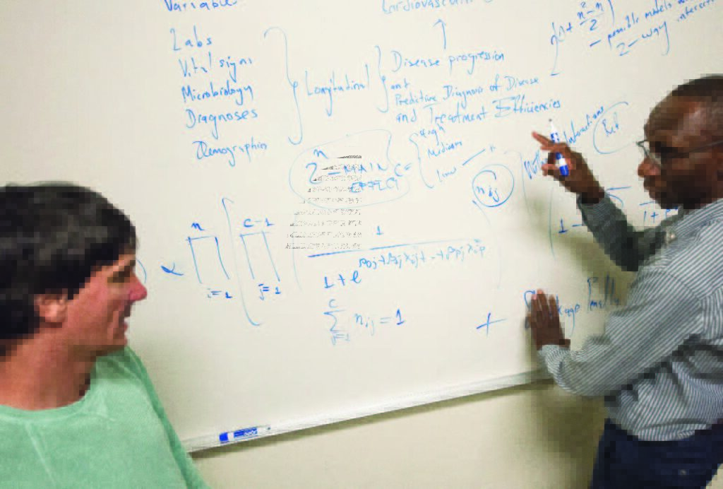 Louis Ehwerhemuepha (MS ’13, Ph.D. ’15), a senior data scientist at CHOC (right), continues to collaborate on research with Chapman faculty members,