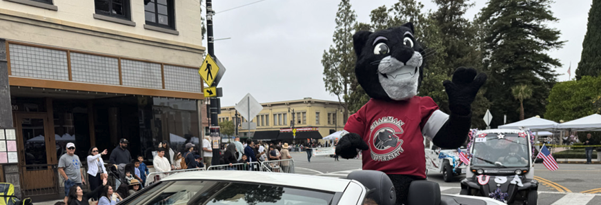 Paws up! Pete the Panther rides through the Orange May Parade, sharing Chapman spirit with the community.