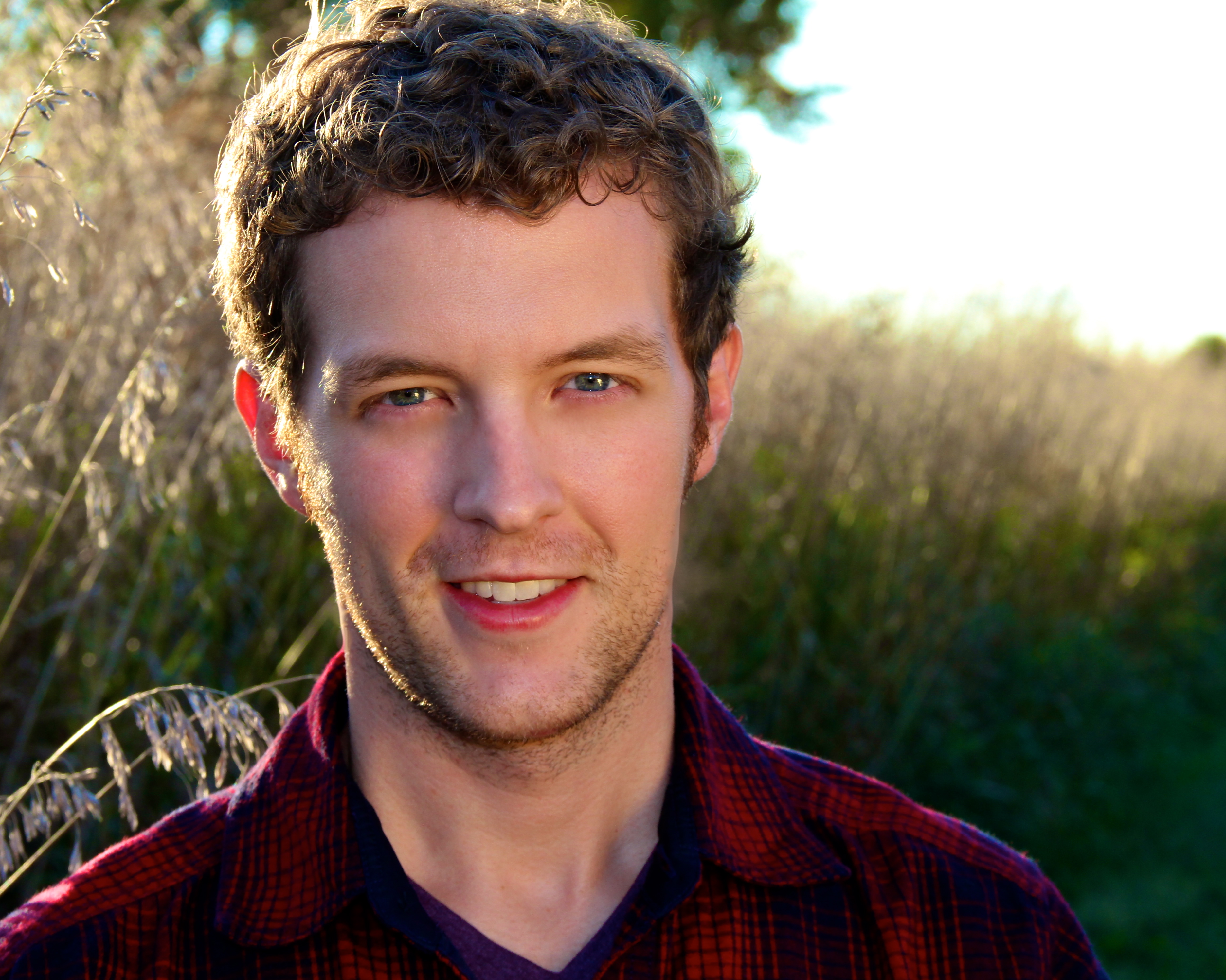 Man smiling in nature.