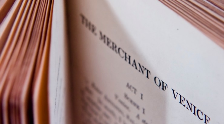 Pages in a book opened to "The Merchant of Venice."