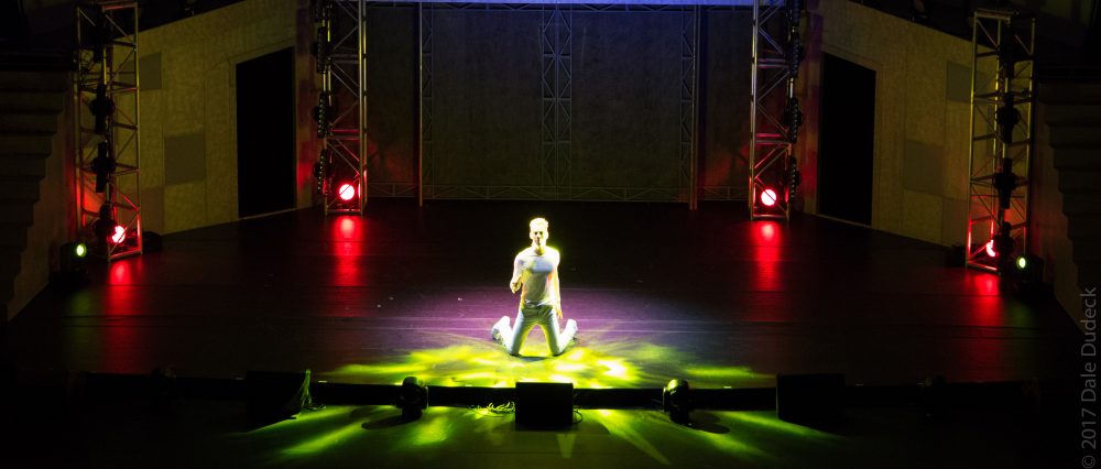 man kneeling on stage
