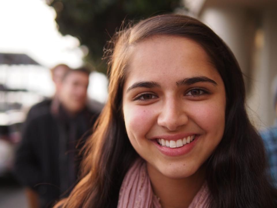 young woman with long brown hair smiling