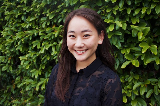young woman with dark hair smiling