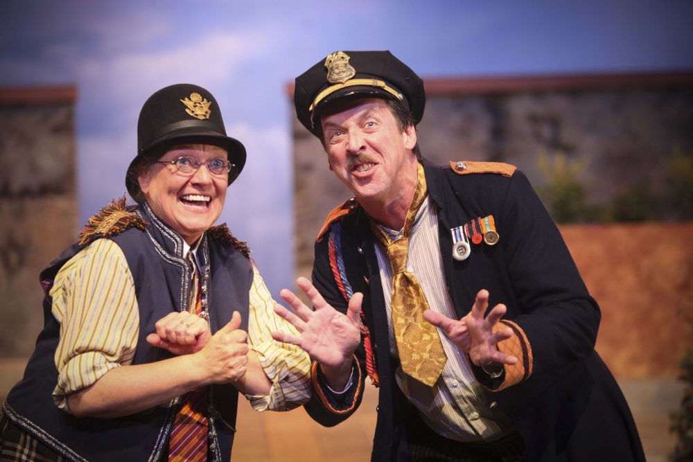 woman and man dressed in old-fashioned police uniforms plotting to do something